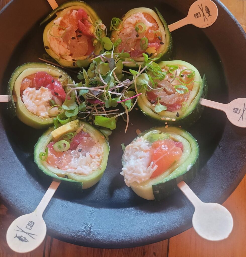 Sushi Lollipops at Sandfish Sushi & Whiskey in Palm Springs, arranged in a circular presentation with cucumber-wrapped rolls and ingredient markers.