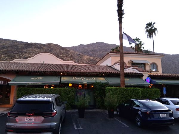Exterior of Bar Cecil Palm Springs against mountains
