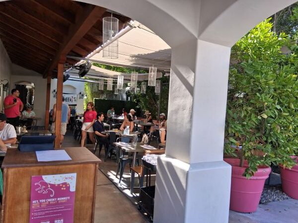 Cheeky’s Palm Springs patio with guests enjoying breakfast in the outdoor dining area.