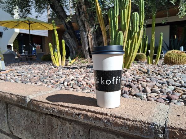 Coffee cup against fountain