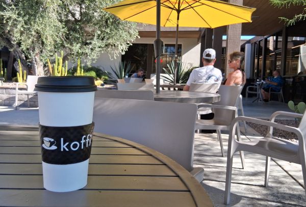 A coffee cup pictured on the patio of Koffi on Tahquitz