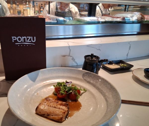 Black cod plated with cherry tomatoes, microgreens, and a glossy marinade at Ponzu Sushi in Palm Springs.