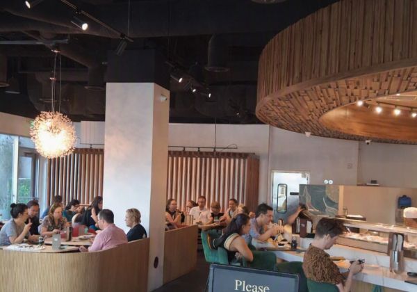 Interior of Ponzu Sushi in downtown Palm Springs with diners enjoying lunch and dinner in a lively, modern dining room.