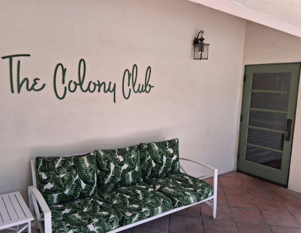 Colony Club’s patio entry with tropical bench and green door