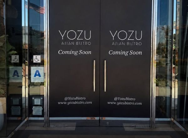 The storefront of Yozu Asian Bistro announcing coming soon
