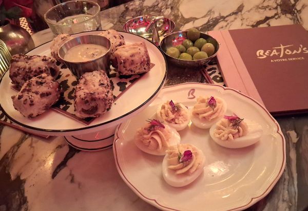 Deviled Eggs and Wagyu Pigs in a Blanket served at Beaton's alongside olives and mustard dipping sauce.
