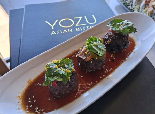 A5 Wagyu Meatballs served with orange peel-infused teriyaki, Thai basil, green onion, and chili at Yozu Asian Bistro in Palm Desert.