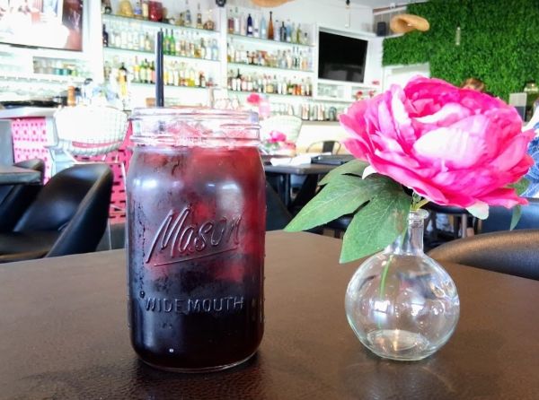 The Jamaica Hibiscus Agua Fresca with the Delicias restaurant in the background