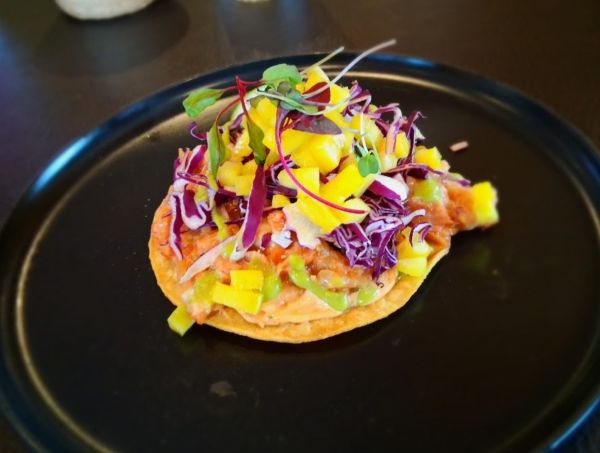 The Vulcan Seafood Toastada with fresh vegetables and mangoes is one of the standout menu items at Delicias