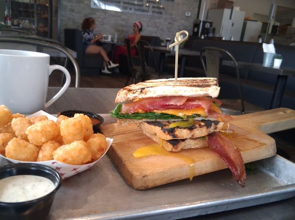 Midnight Sandwich at Heirloom Craft Kitchen Indio - applewood bacon fried egg spinach cheddar garlic herb aioli on grilled sourdough with tater tots