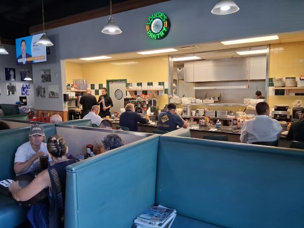 Customers eat at booths and at counter at Louise's Pantry in La Quinta